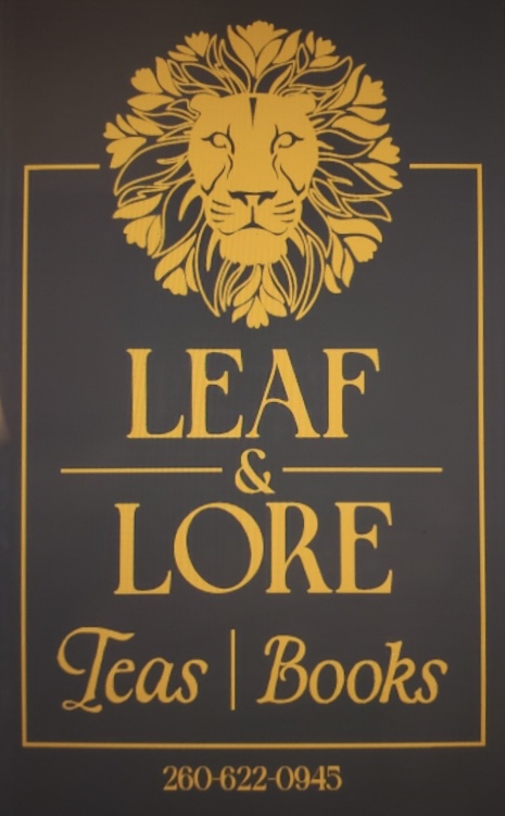 Leaf & Lore logo — gold lion emblem with the shop name, Teas | Books, and phone number 260-622-0945 on a dark background